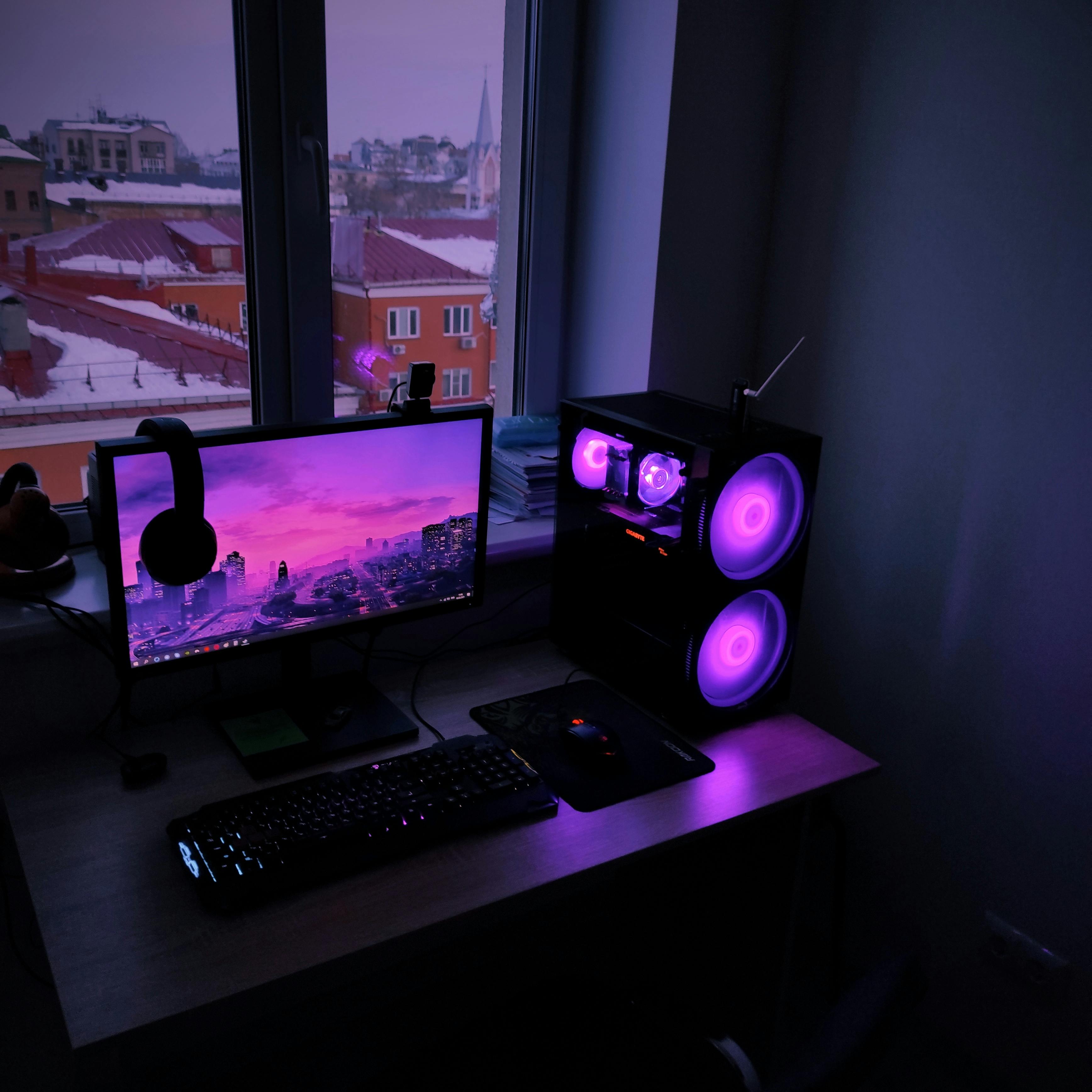 Person using a screwdriver to open a laptop on a workbench