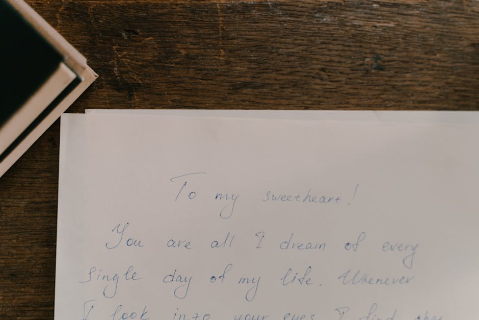 A heartfelt handwritten letter on paper placed on a wooden table.