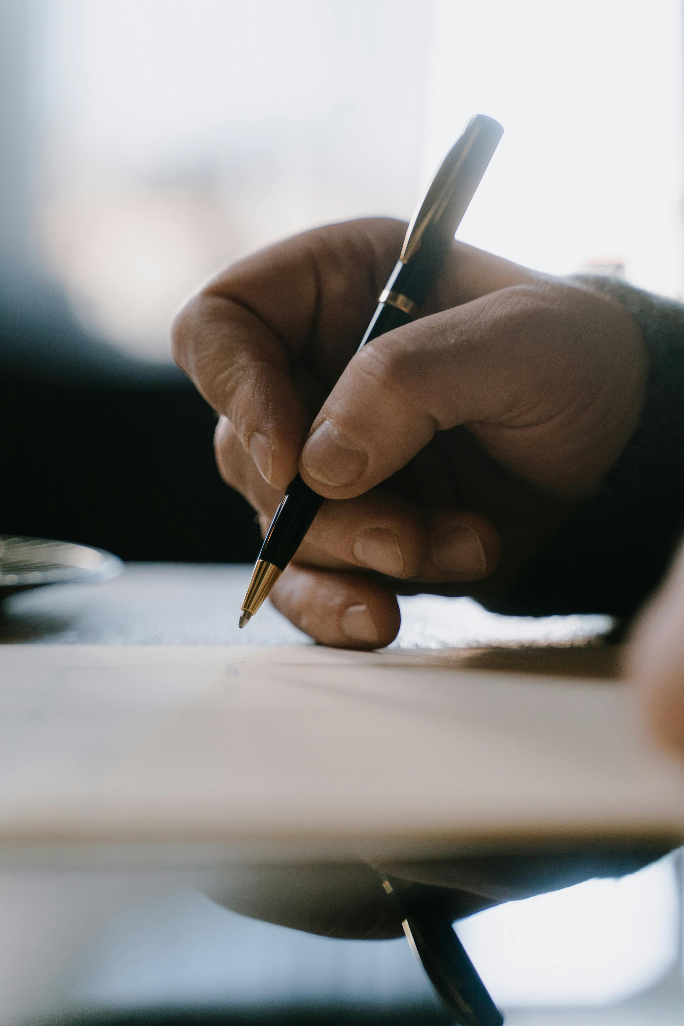 hand of a person writing on a paper