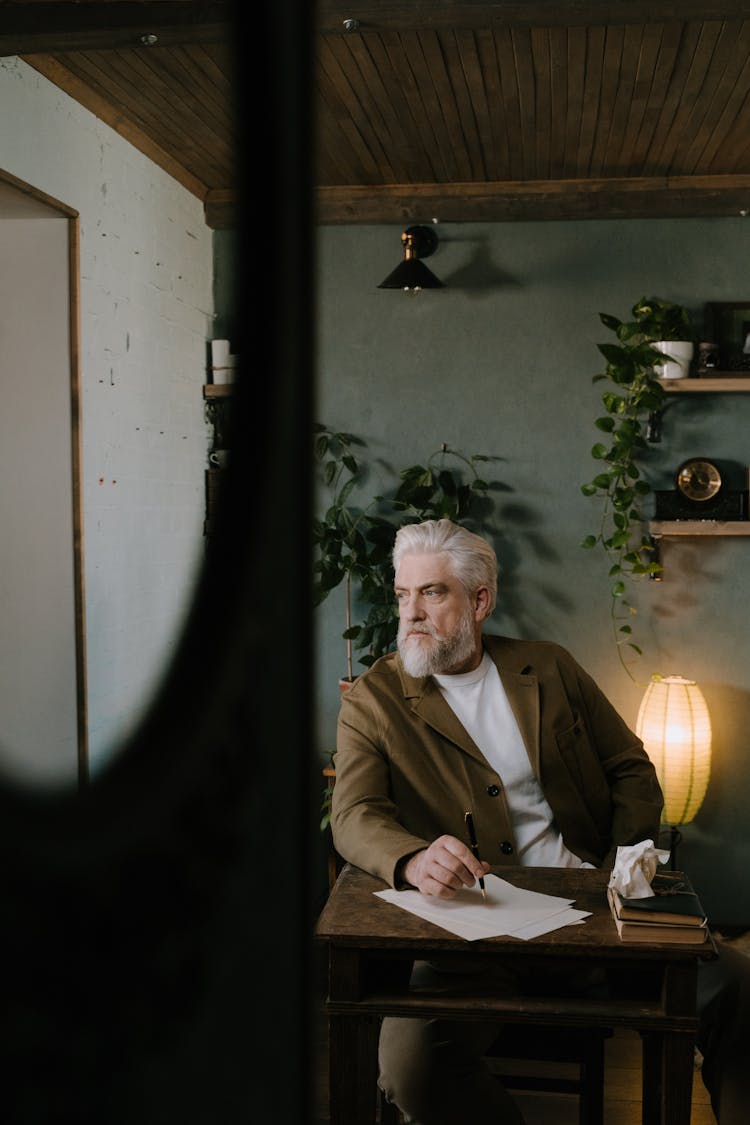 A Man Composing A Handwritten Letter 