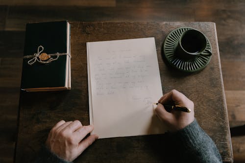 Free A Person Composing a Personal Letter Stock Photo