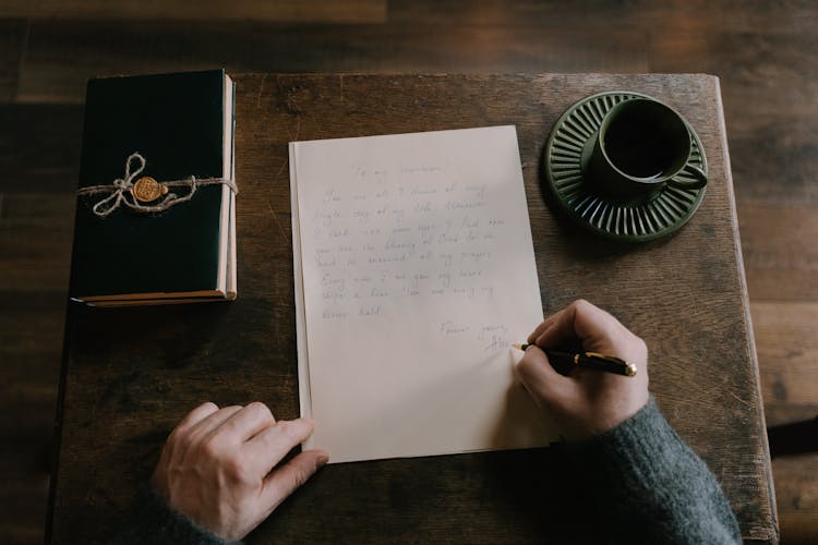 A Person Composing A Personal Letter