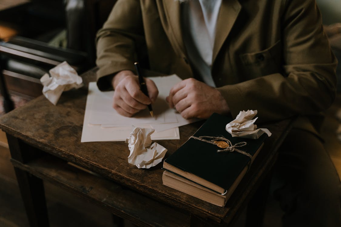 Person writing on a White Paper