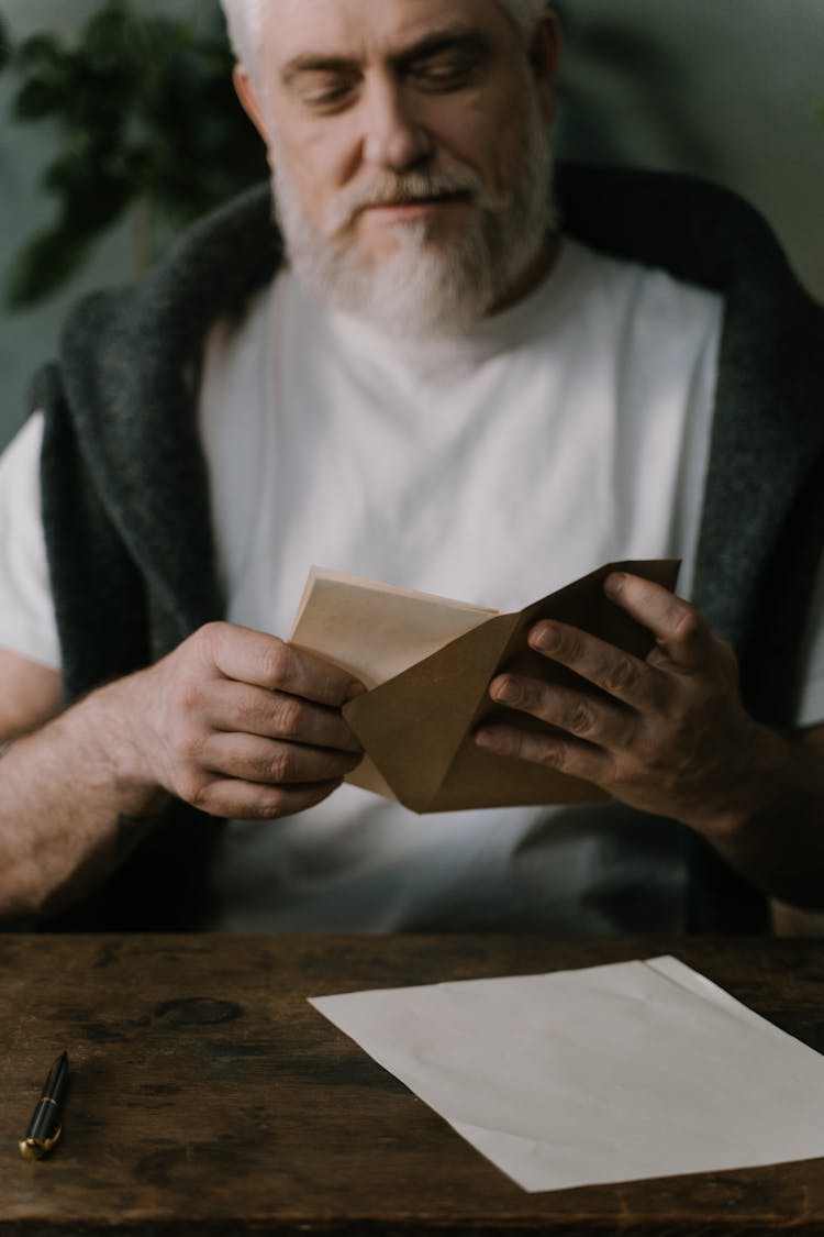 A Man Holding An Envelope