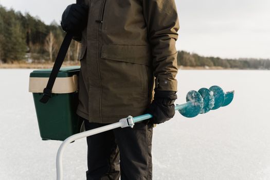 A Man Holding an Ice Auger