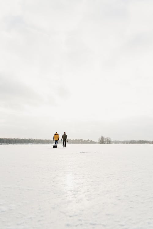 Men Walking on the Snow