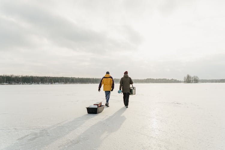 Explorers Out Walking In Frozen Lake