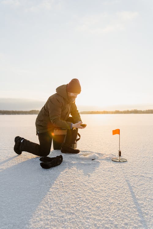 A Man Fishing on the Snow