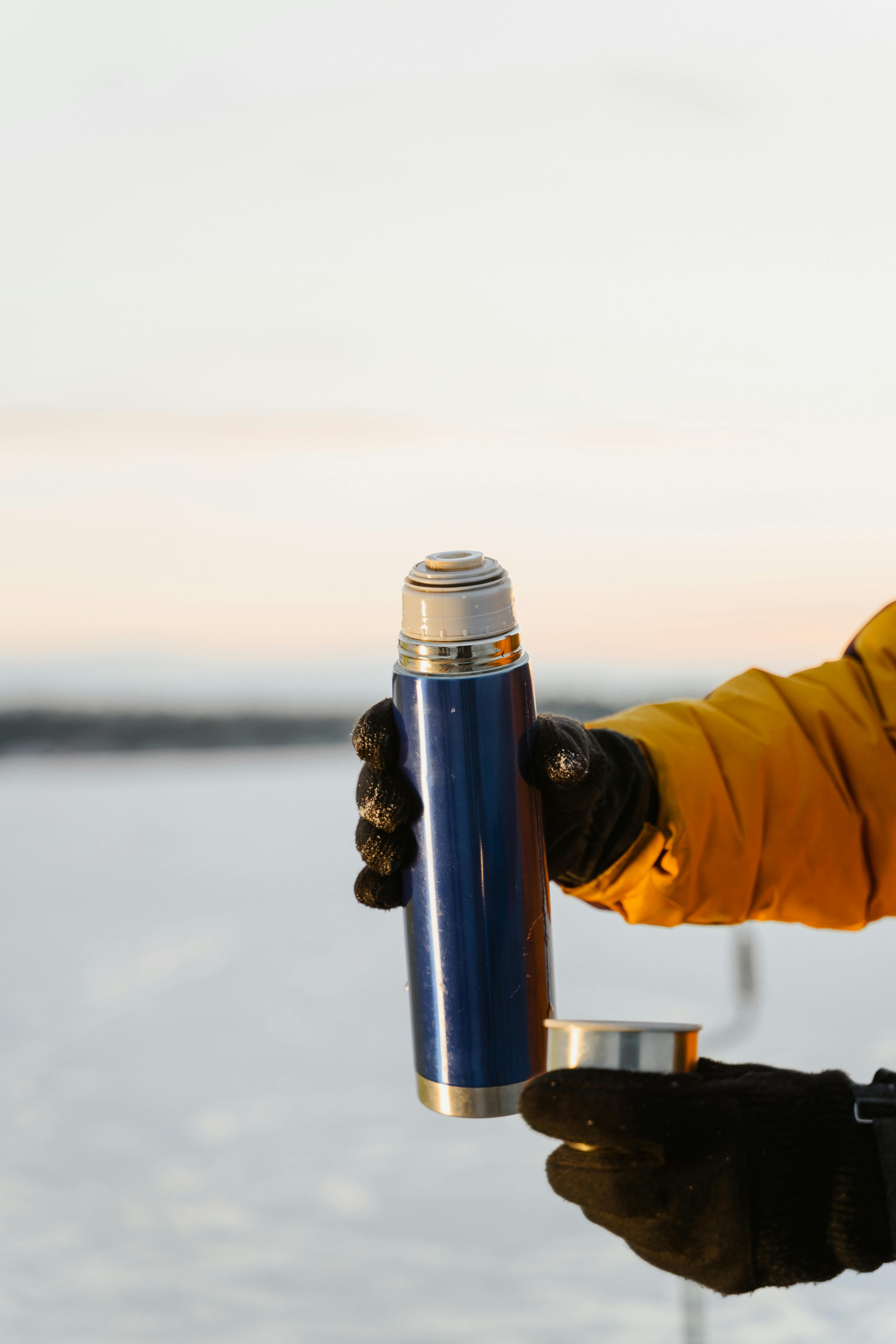 Anonymous Men Using Thermos Stock Photo - Download Image Now