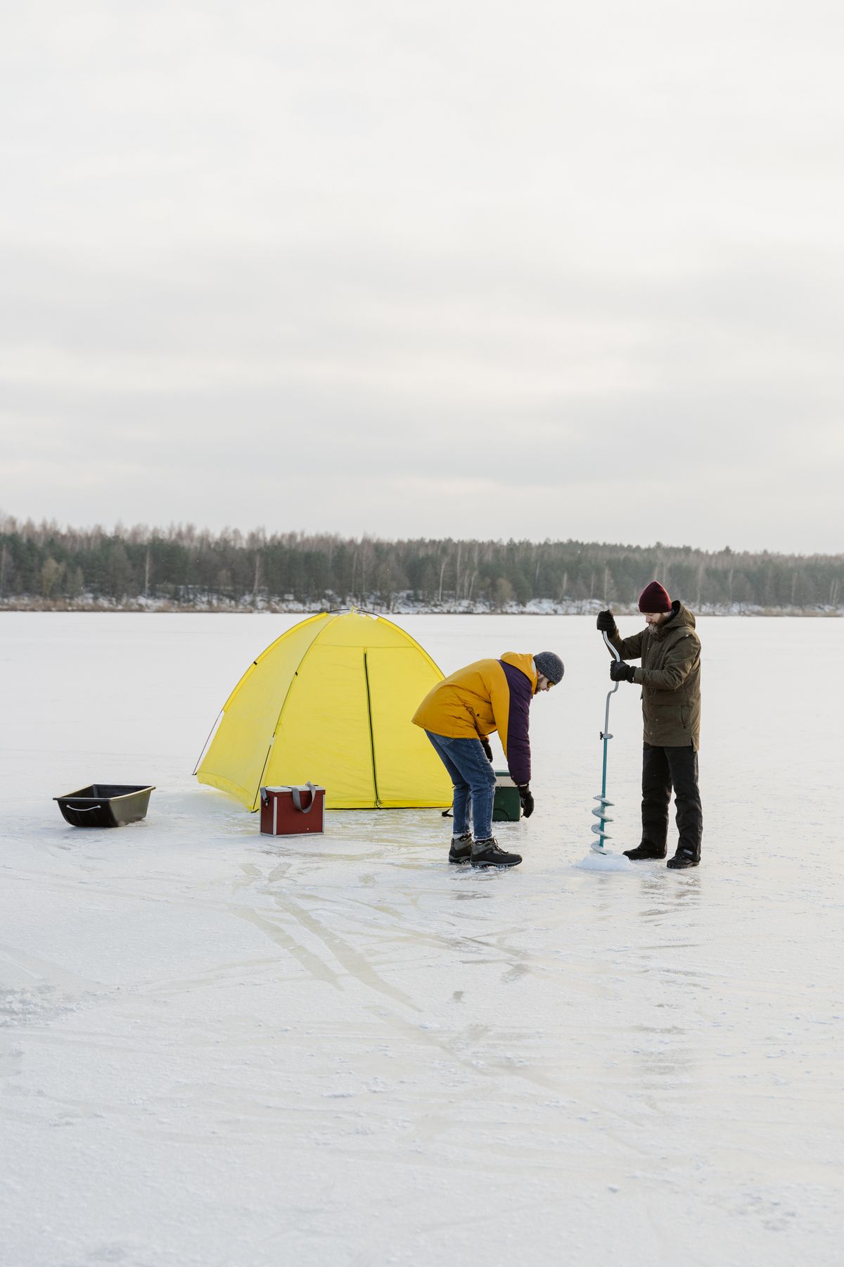 Kid fishing through ice hole