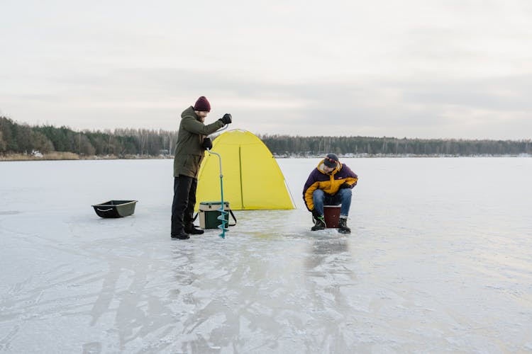 Men Camping On Frozen Lake