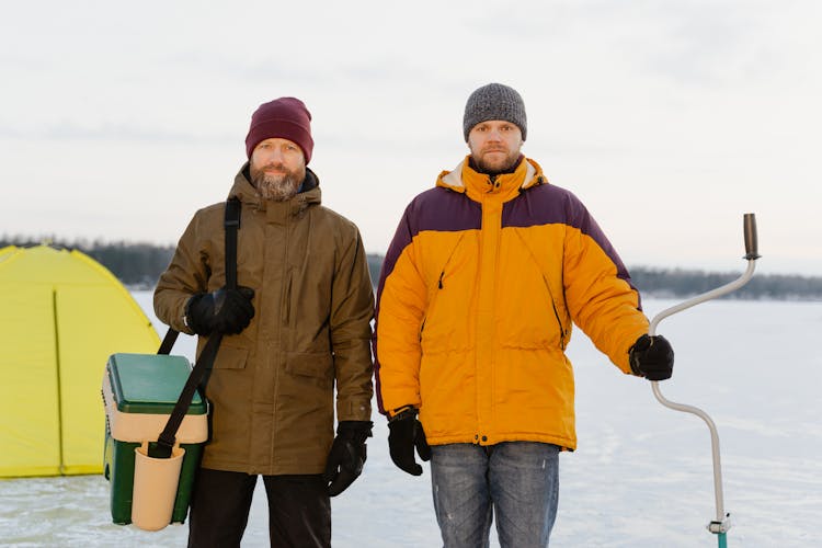 Men Standing On A Frozen Lake