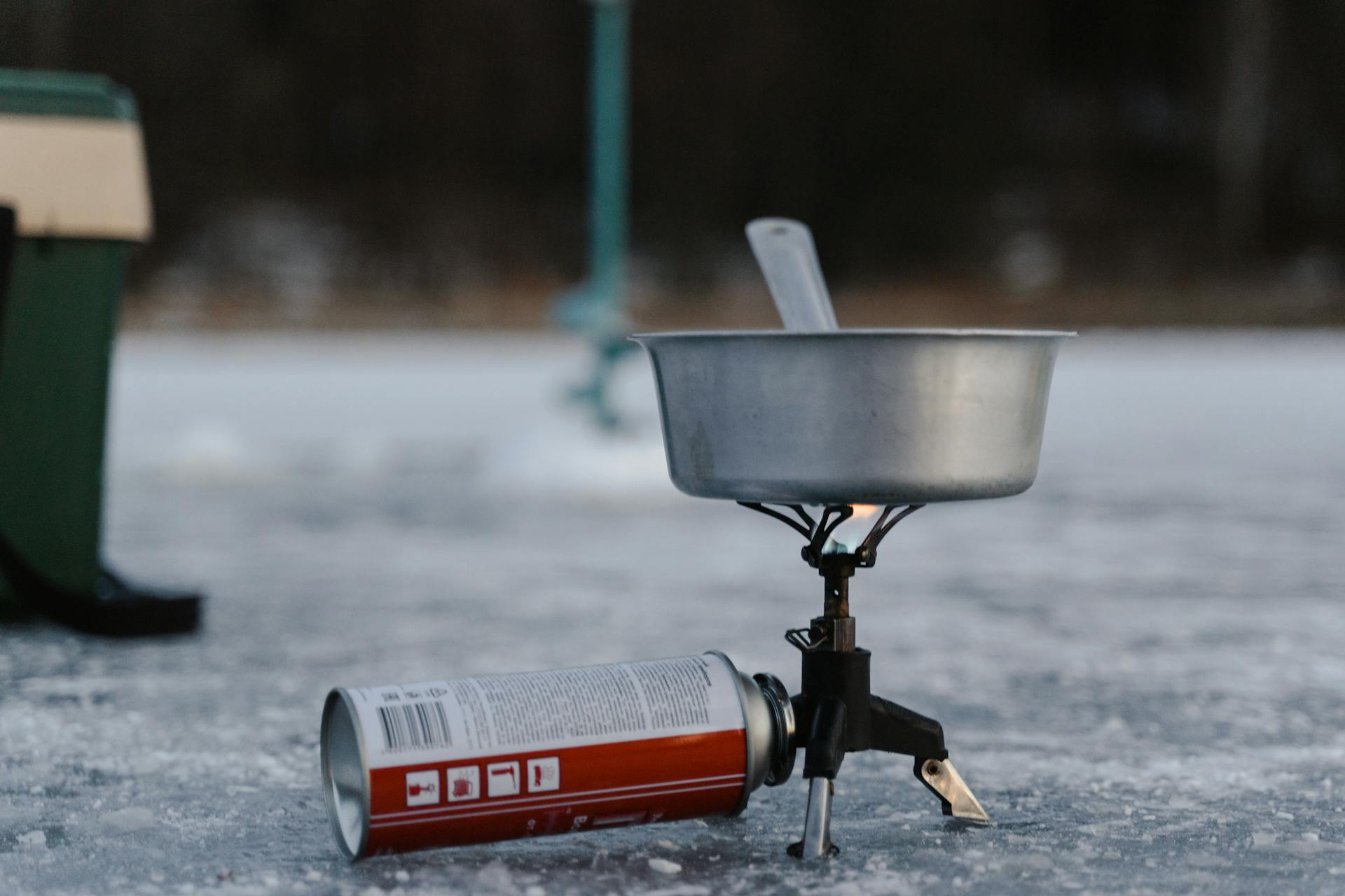 A Stainless Pot on a Camping Stove with a Can of Butane