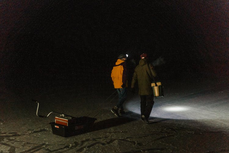 Men Walking On Frozen Lake