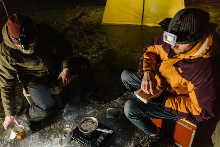 Men Eating On Frozen Lake