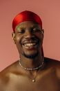 Smiling Man Wearing Gold Necklace