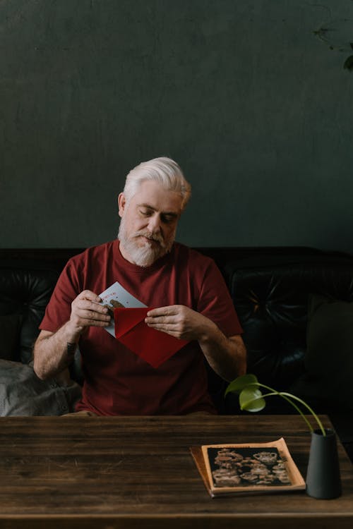 Free A Elderly Man Getting a Letter From an Envelope Stock Photo