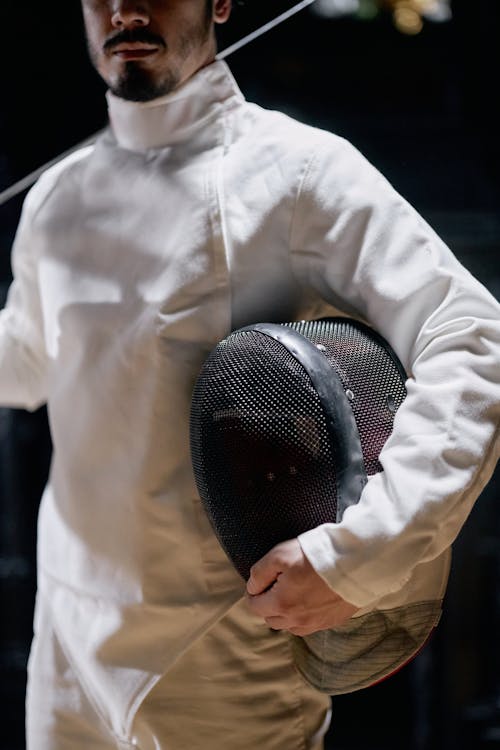 Free Man Holding a Fencing Mask Stock Photo