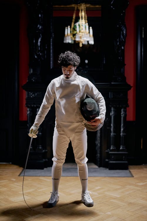 Man in Holding Fencing Mask and Sword