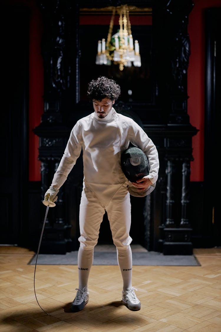 Man In Holding Fencing Mask And Sword