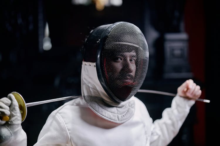 A Portrait Of A Fencer Holding A Foil