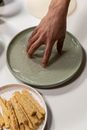 Person Holding Stainless Steel Round Plate