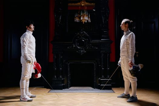 Men in White Long Sleeves and White Pants Holding Silver Fencing Sword