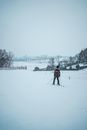 Person in Black Jacket and Black Pants Standing on Snow Covered Ground
