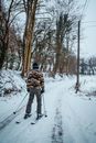Man in Brown and Black Camouflage Jacket and Black Pants Riding Ski Blades on Snow Covered