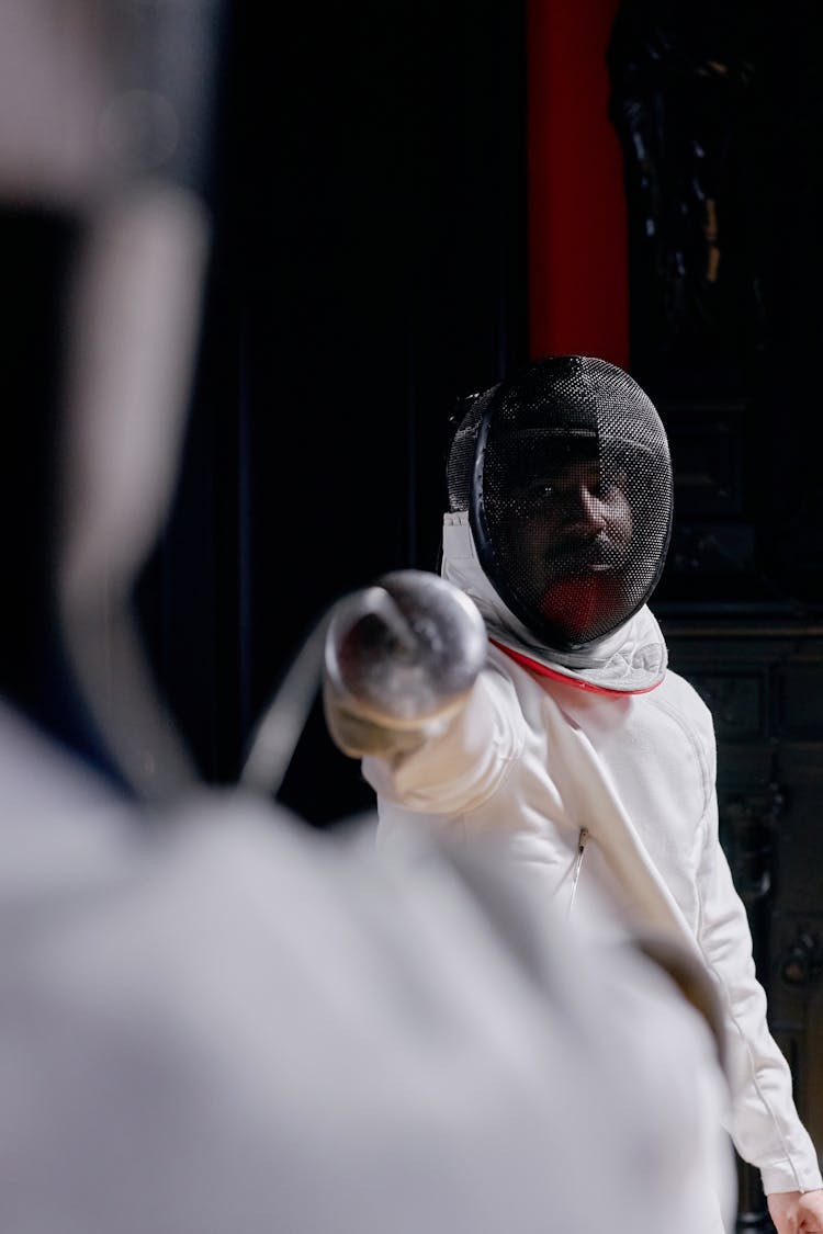 An Over The Shoulder Shot Of A Fencer Holding A Sword