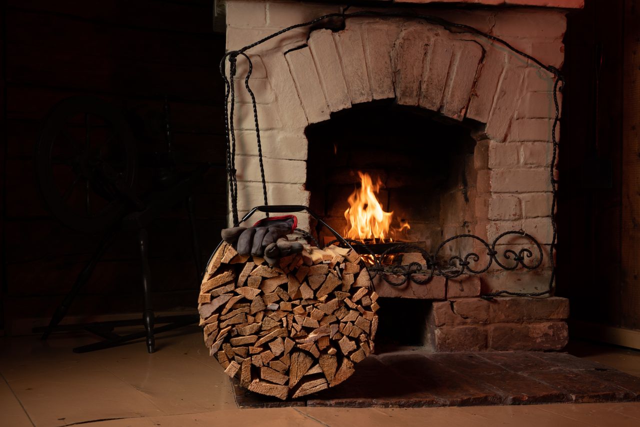 a warm fireplace with a stack of firewood evokes comfort and relaxatio