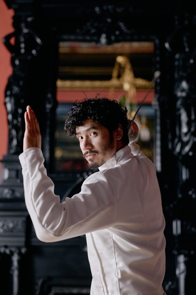 A Man Engaged In The Sport Of Fencing