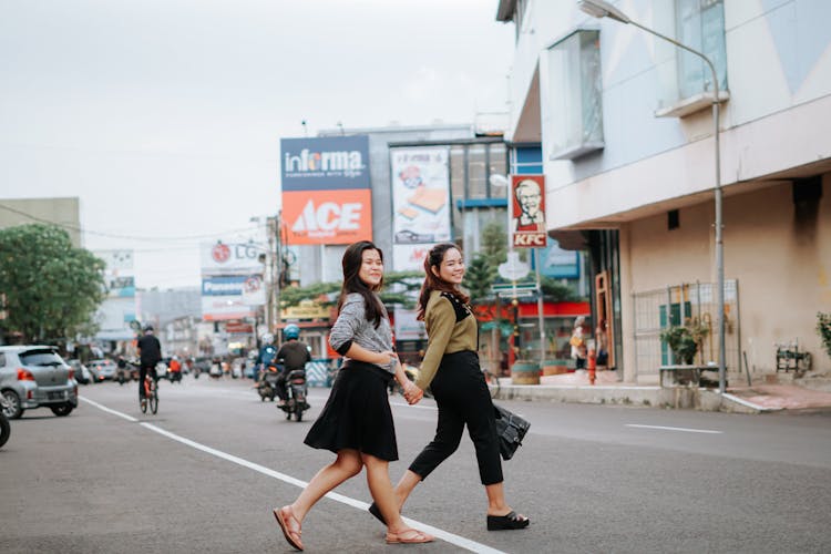 Two Girls Walking On The Street