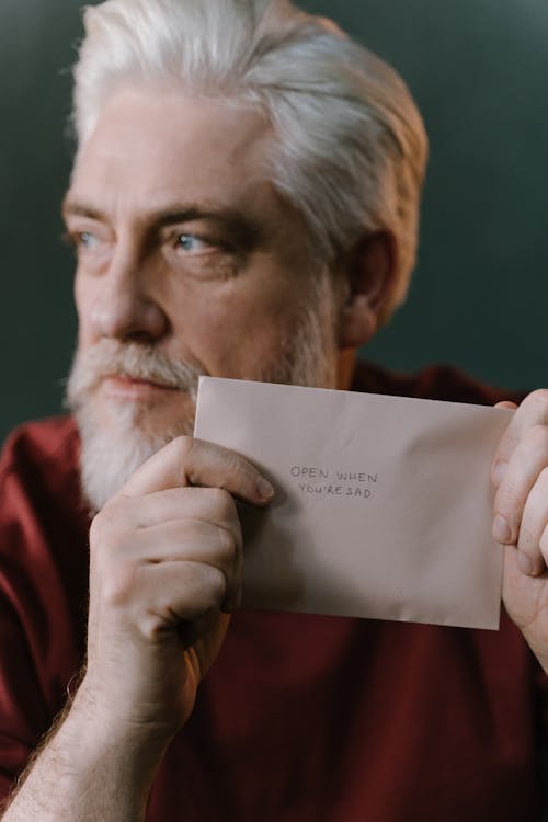 Free Elderly Man Holding an Envelope Stock Photo