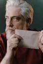 Elderly Man Holding an Envelope