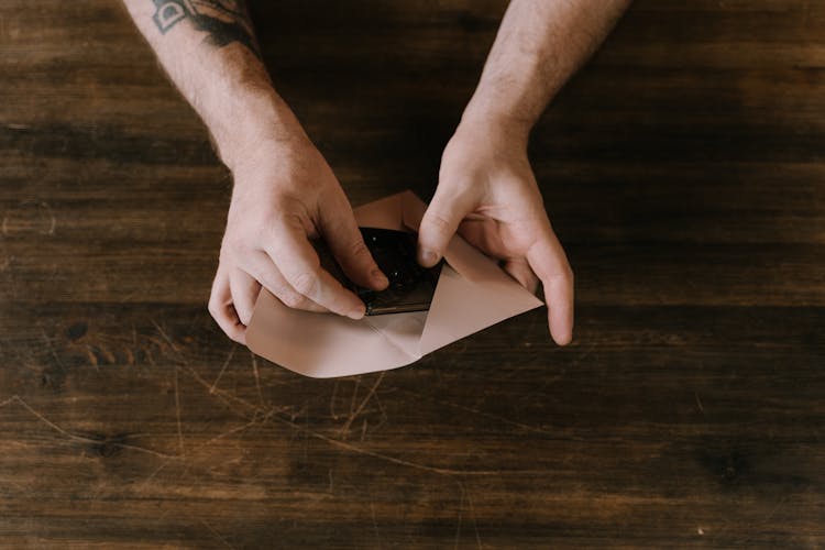 Person Holding A Cassette Tape And An Envelope