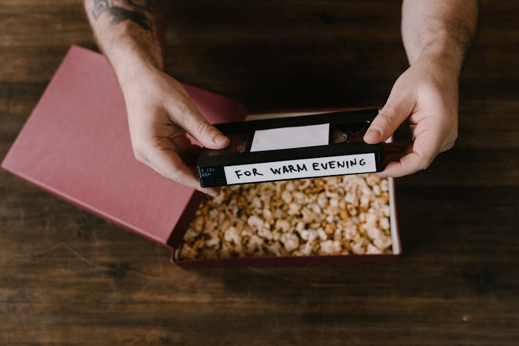 A Person Holding A Videotape