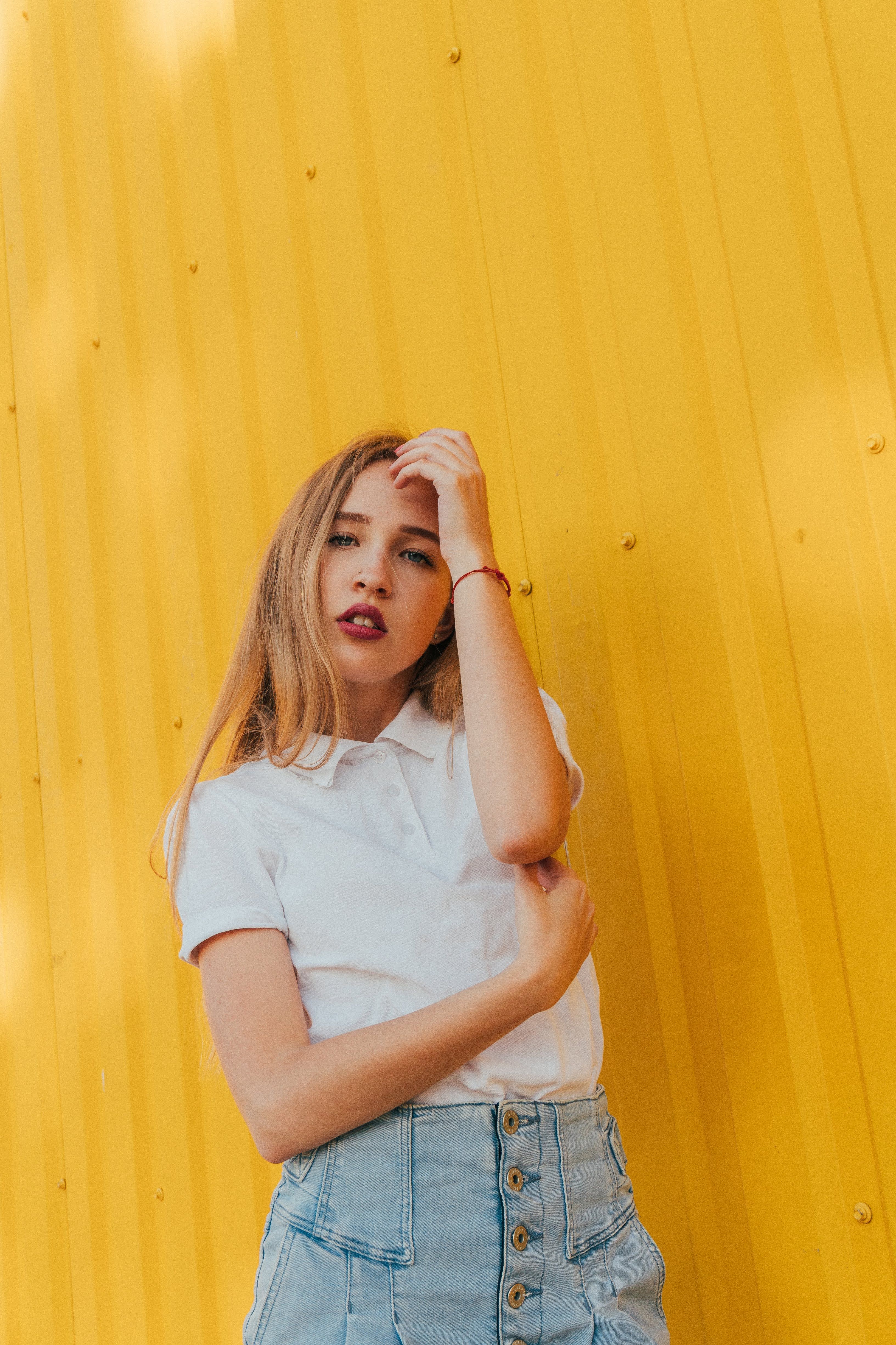 Woman in a cream knit polo with chinos
