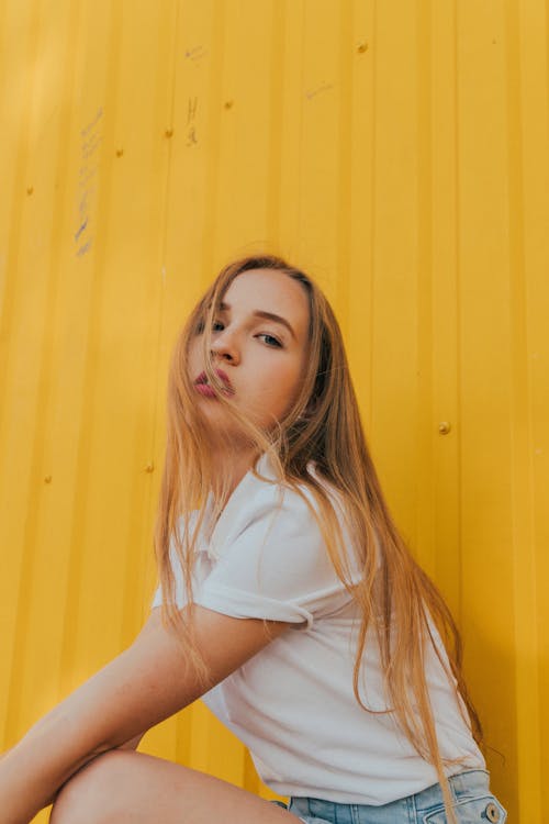 Serious young female millennial chilling on street and looking at camera