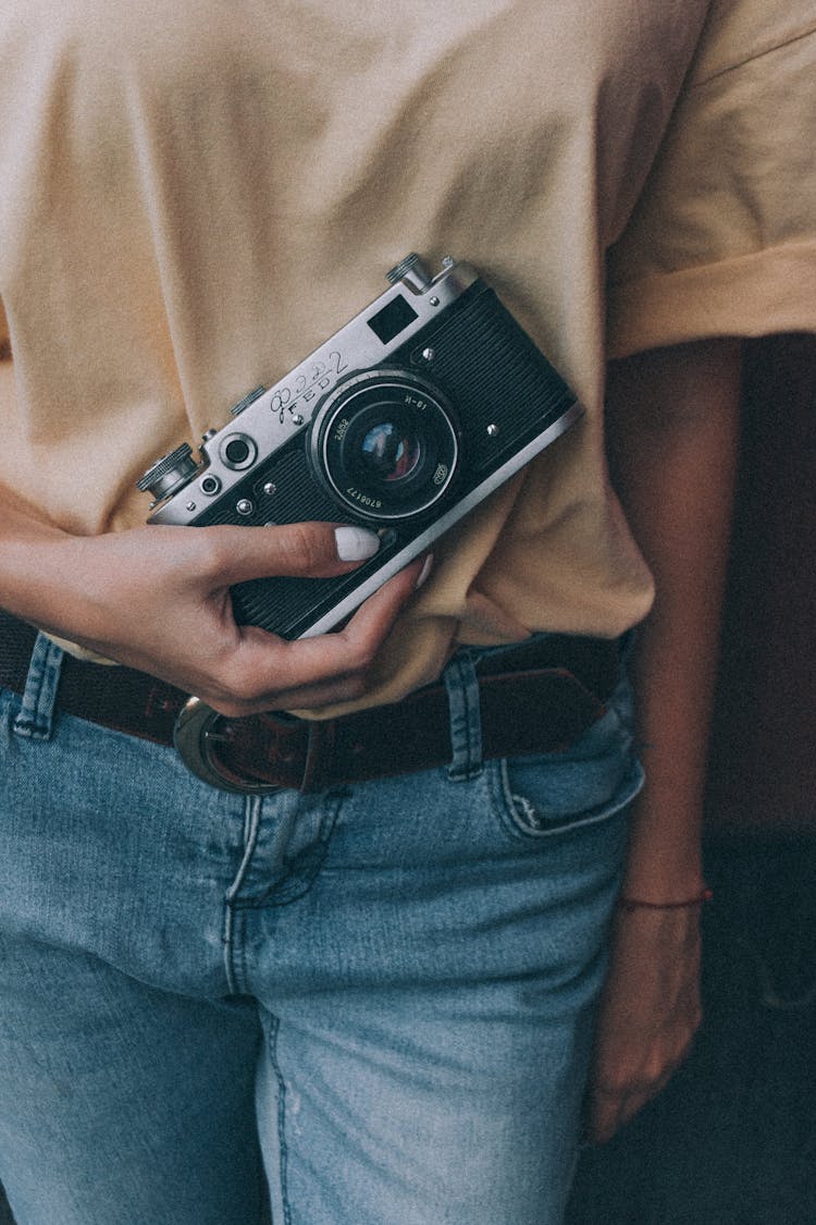 Unrecognizable Woman Demonstrating Retro Photo Camera