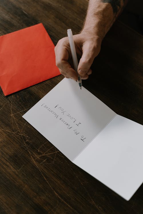 Person Writing on a Valentine's Card