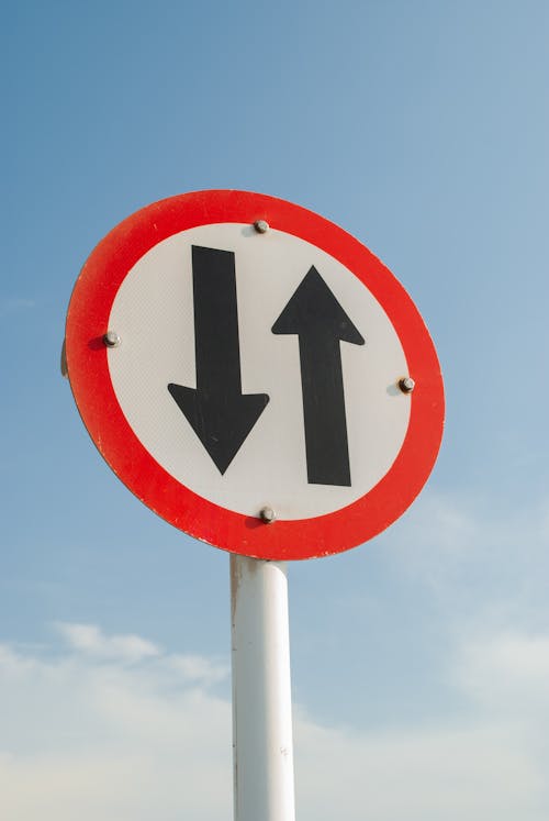 Two Way Traffic Sign Under Blue Sky