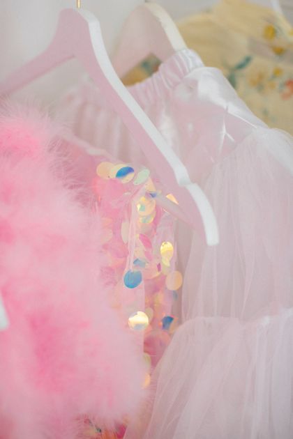 Pale dresses on white hangers in a boutique — Martin de Arriba on Pexels