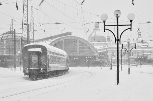 Snow Covered Ground Around A Train Station