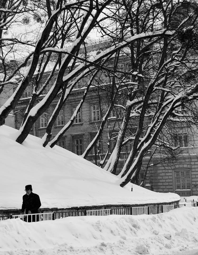 Elderly Man Walking In City After A Heavy Snowfall 