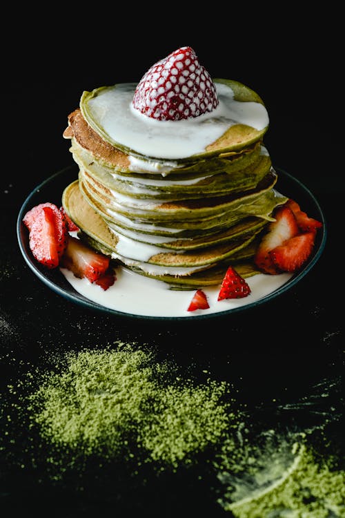 Stack of Matcha Pancakes with Milk and Strawberry on Top