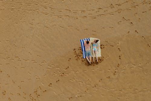 A Couple Lying on Beach Sand