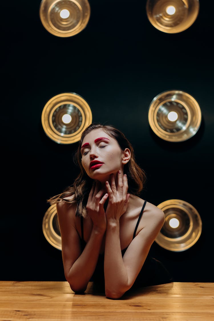 Woman In Black Spaghetti Strap Top Wearing Red Eyebrows And Red Lipstick