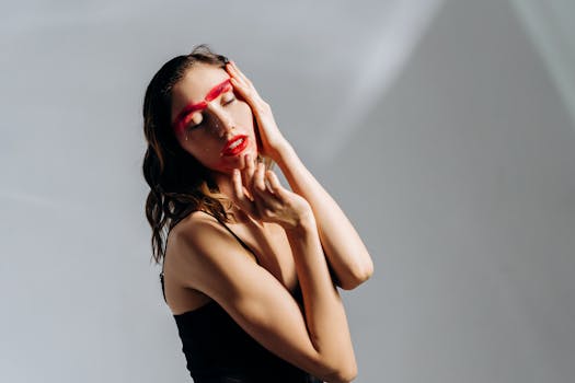 Artistic portrait featuring a woman with bold creative makeup and closed eyes.