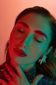 Colorful portrait of a woman with creative makeup and bold fashion style.